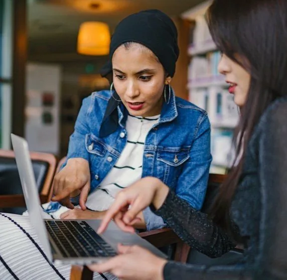 women watching computer screen